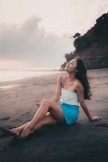 Smiling guest enjoying a peaceful moment on the beach near the hotel.