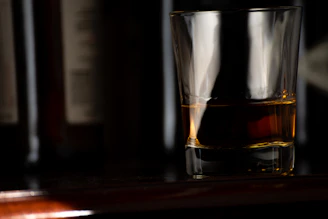 Elegant packaging of amber aura whiskey gift sets arranged on a textured amber gold fabric.