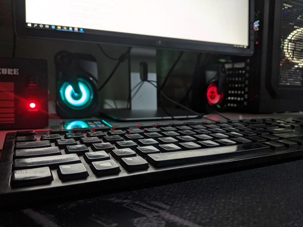 black computer keyboard beside black flat screen computer monitor