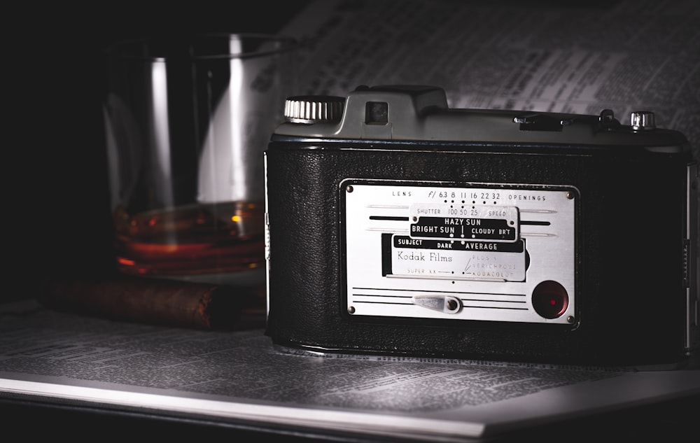 black and silver camera on black leather case