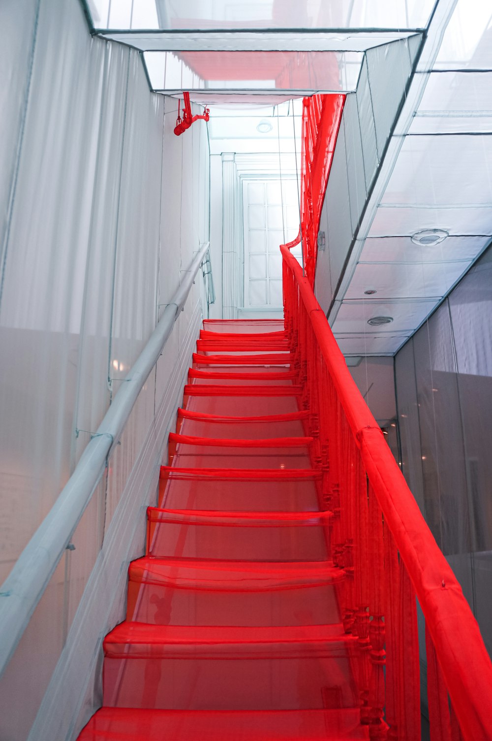 red staircase with white railings