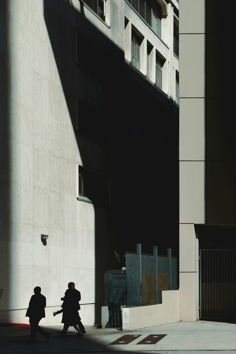 people walking on sidewalk near building during daytime