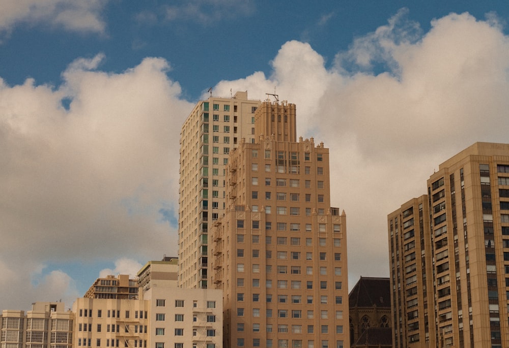 white and brown high rise buildings under blue sky