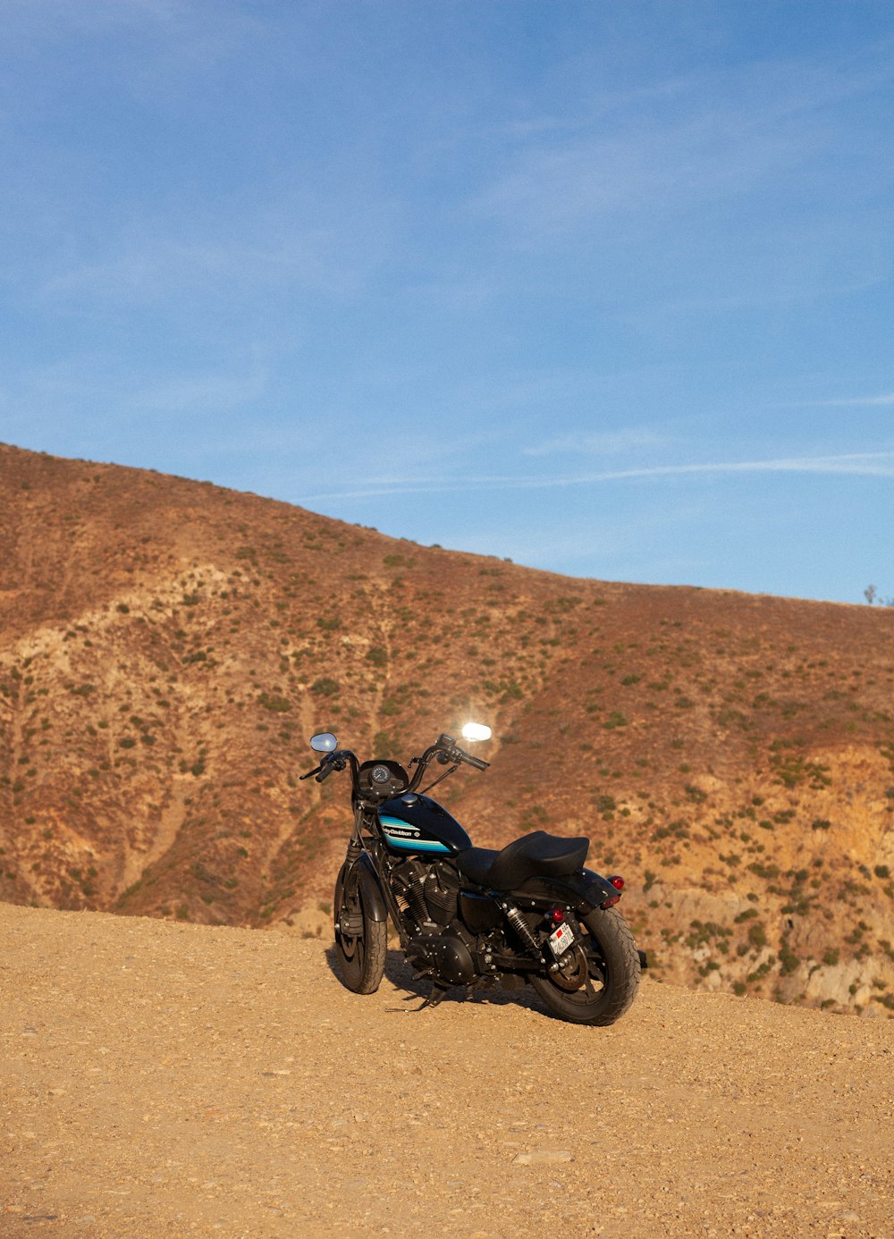 black and gray motorcycle on brown sand during daytime