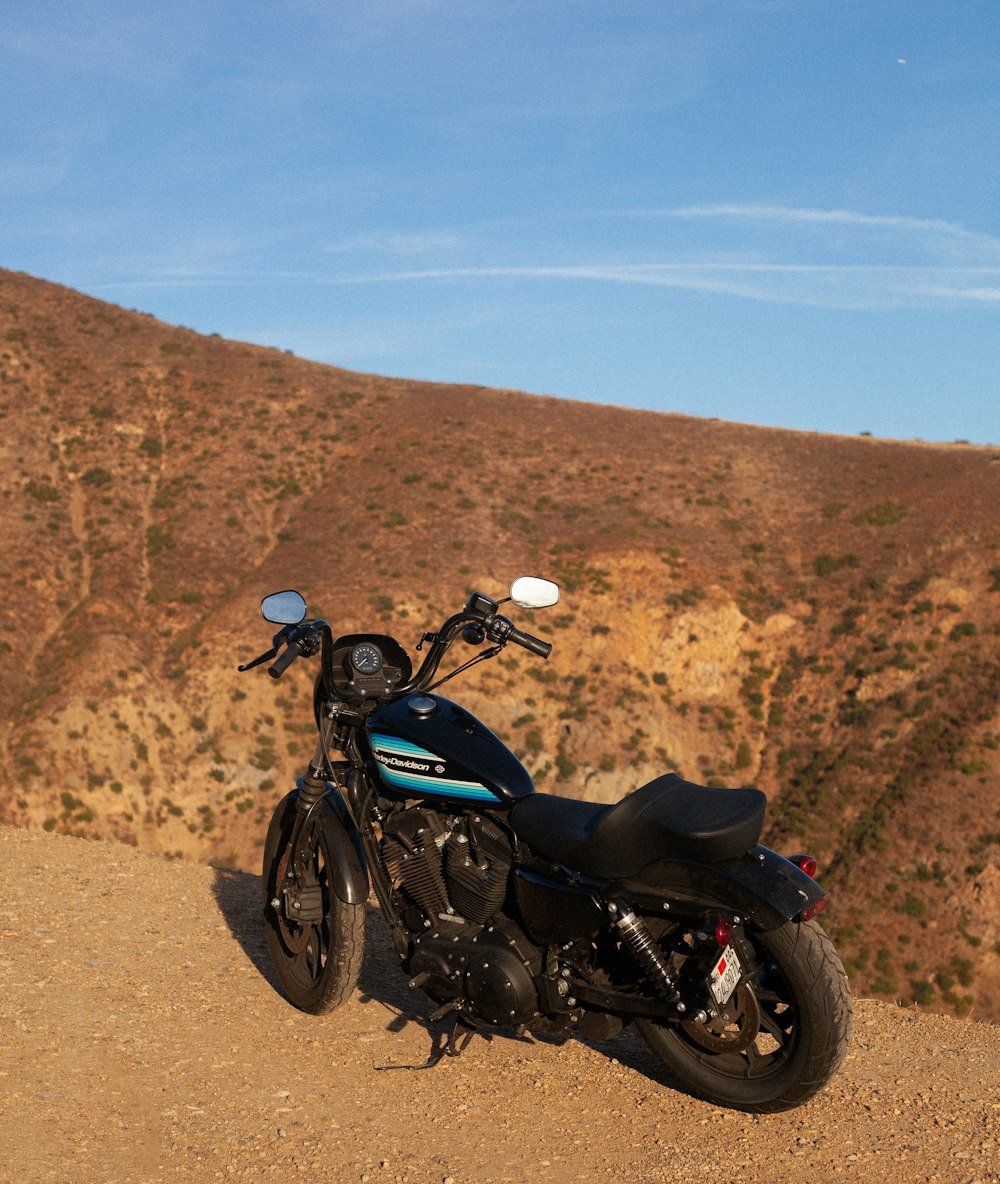 black and red motorcycle on brown dirt road during daytime