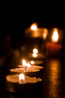 lighted candles on brown wooden table