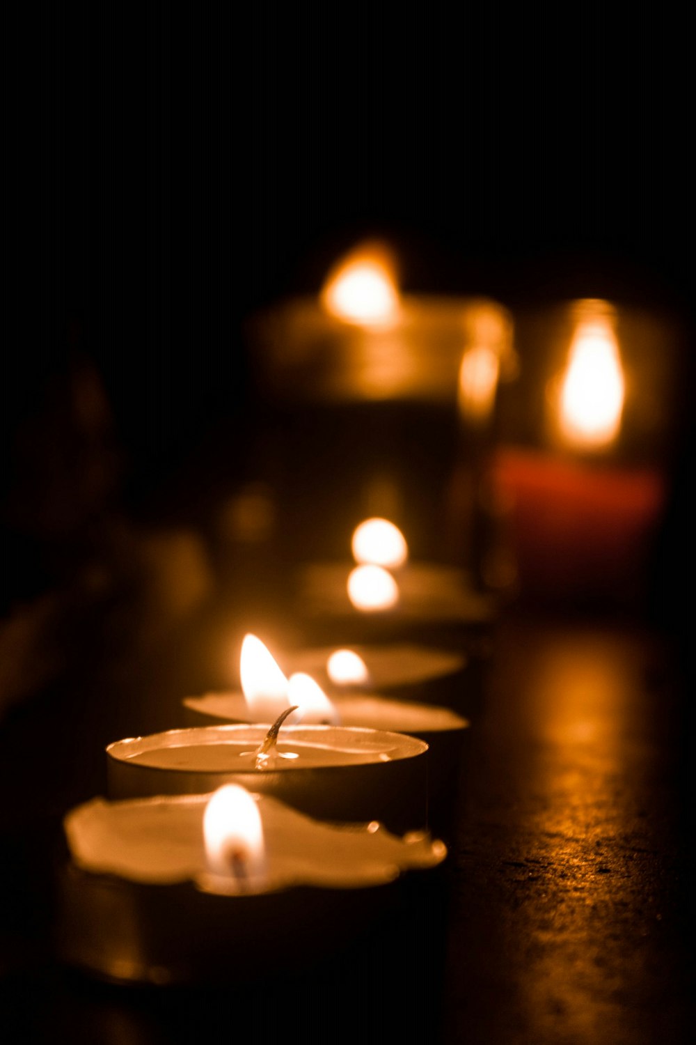 lighted candles on brown wooden table