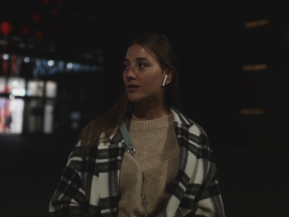 woman in black and white plaid coat