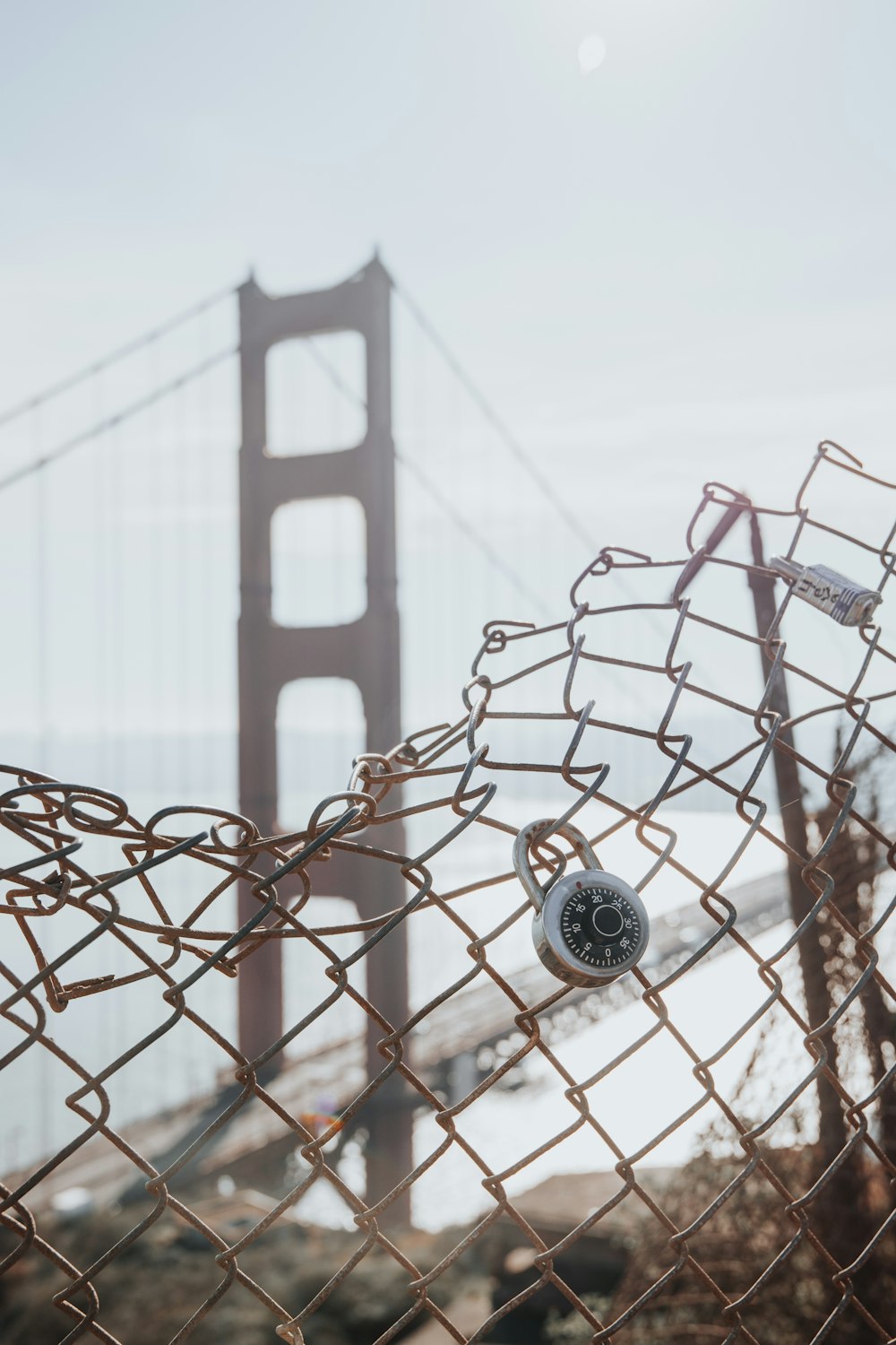 grey metal chain link fence with golden gate bridge in background during daytime