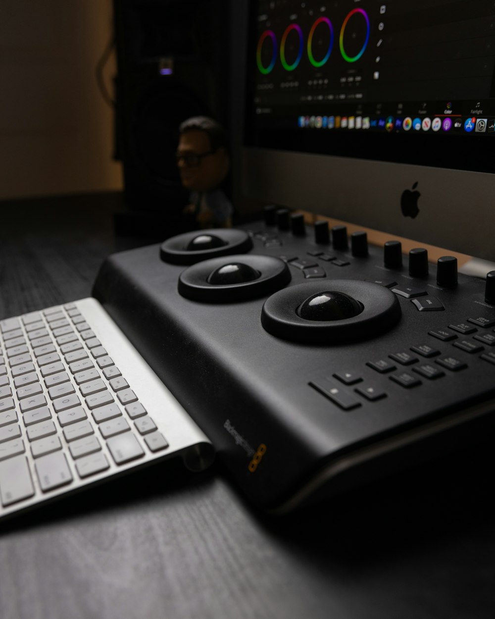 black game controller on black and silver macbook