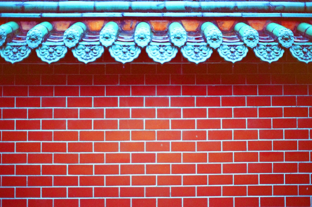 red brick wall with brown wooden window