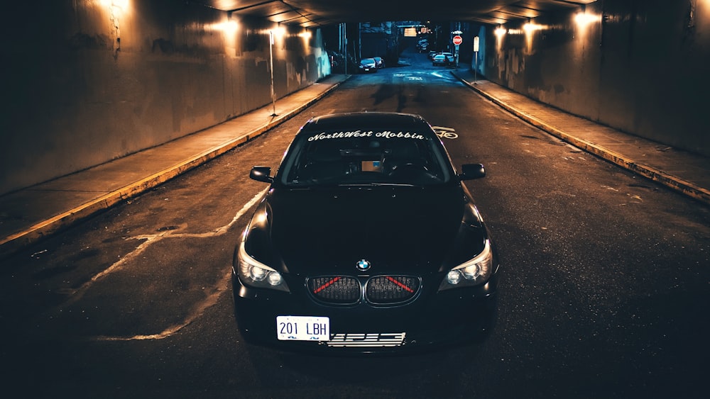 black bmw car on road during night time