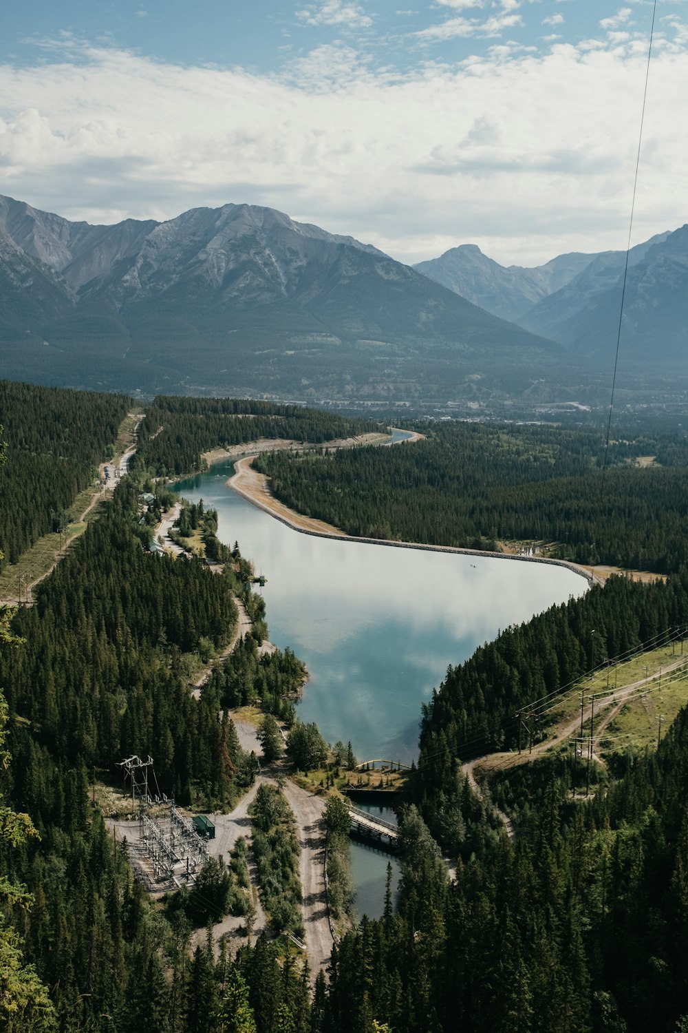 green trees near lake and mountains during daytime