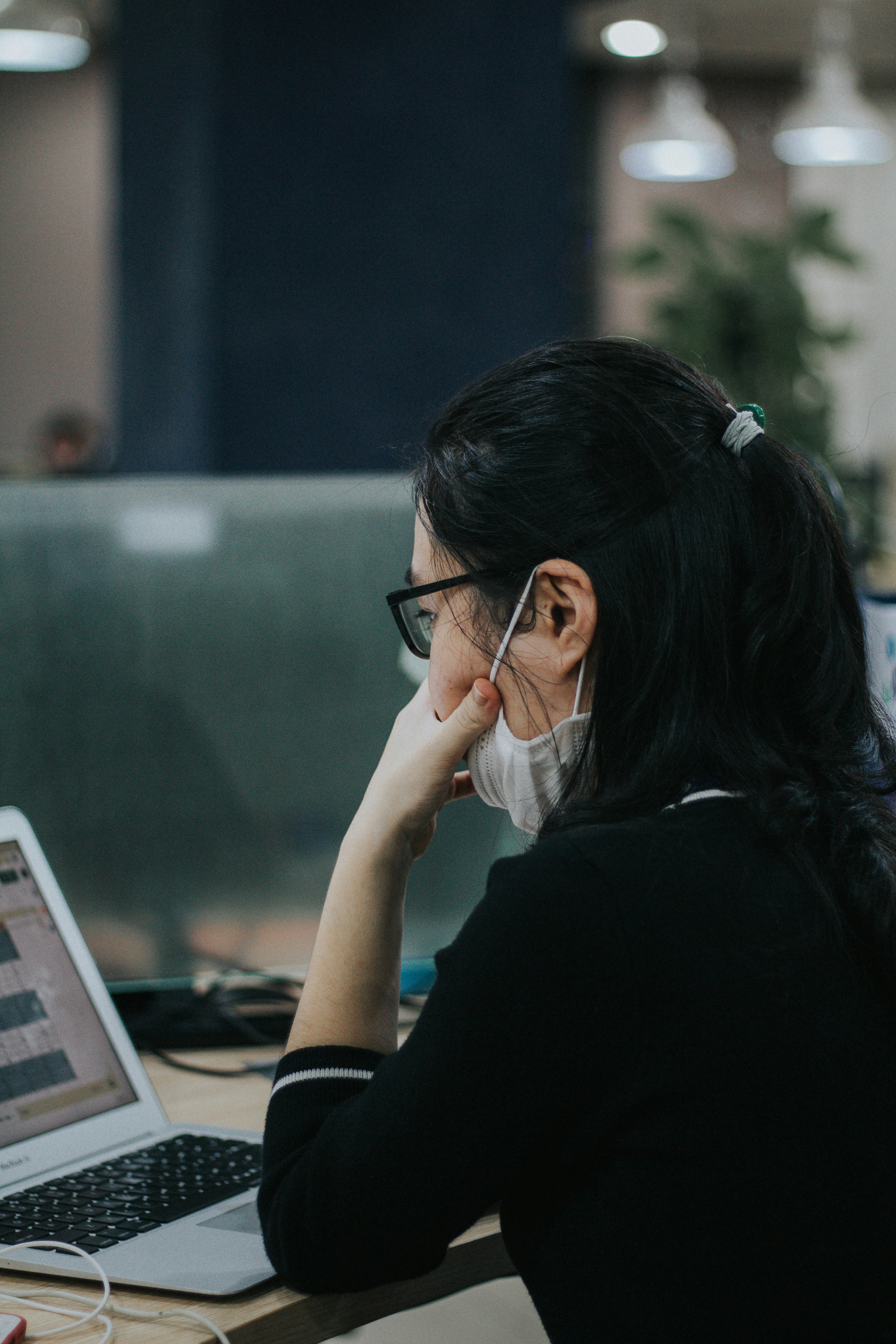 woman in black long sleeve shirt using laptop computer