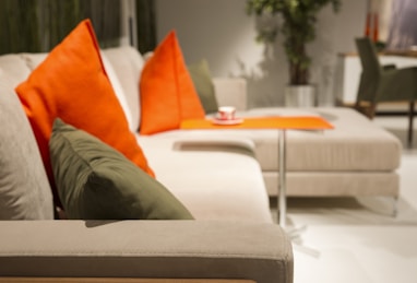 orange throw pillow on white couch