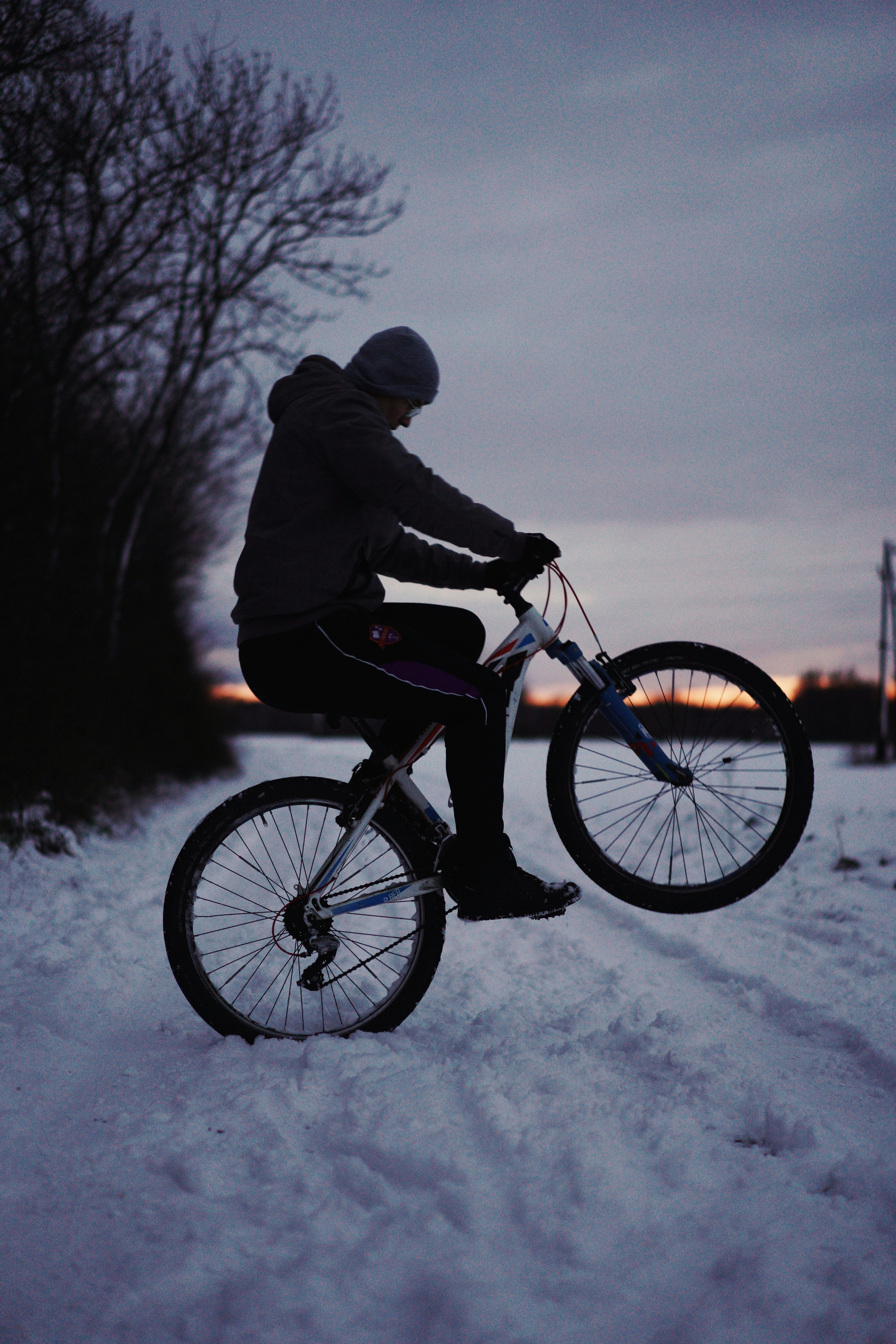 person riding on black mountain bike during daytime
