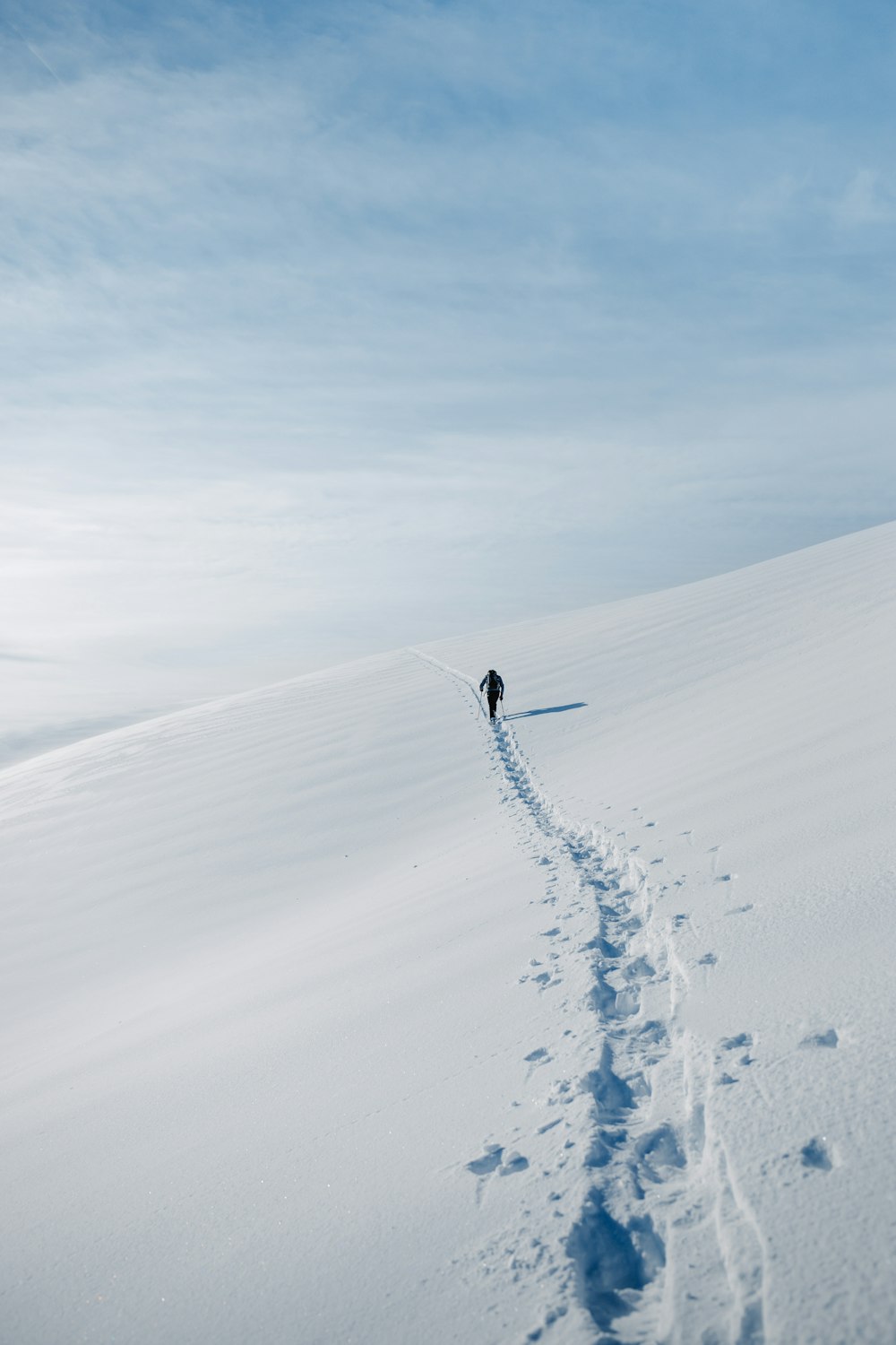 a person walking across a snow covered field