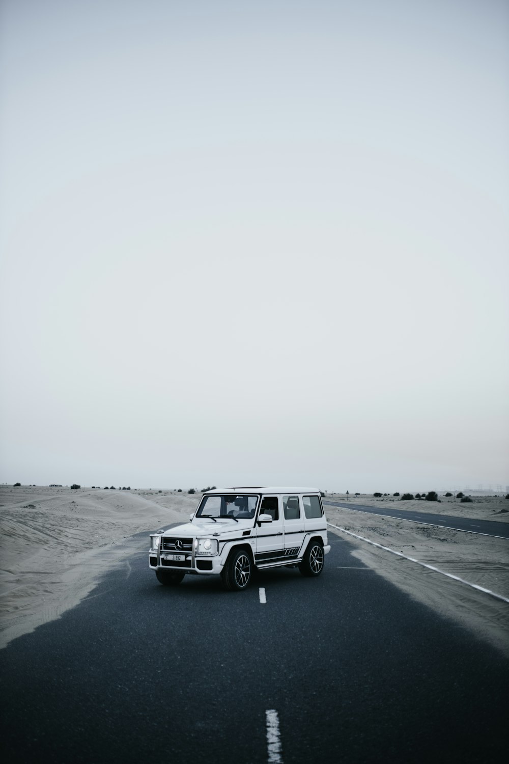 white suv on gray asphalt road