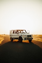 white suv on brown sand during daytime