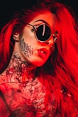 woman with red hair wearing black sunglasses