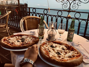 An inviting table setting at Pirata's Pizza with a variety of pizzas and a cozy atmosphere.