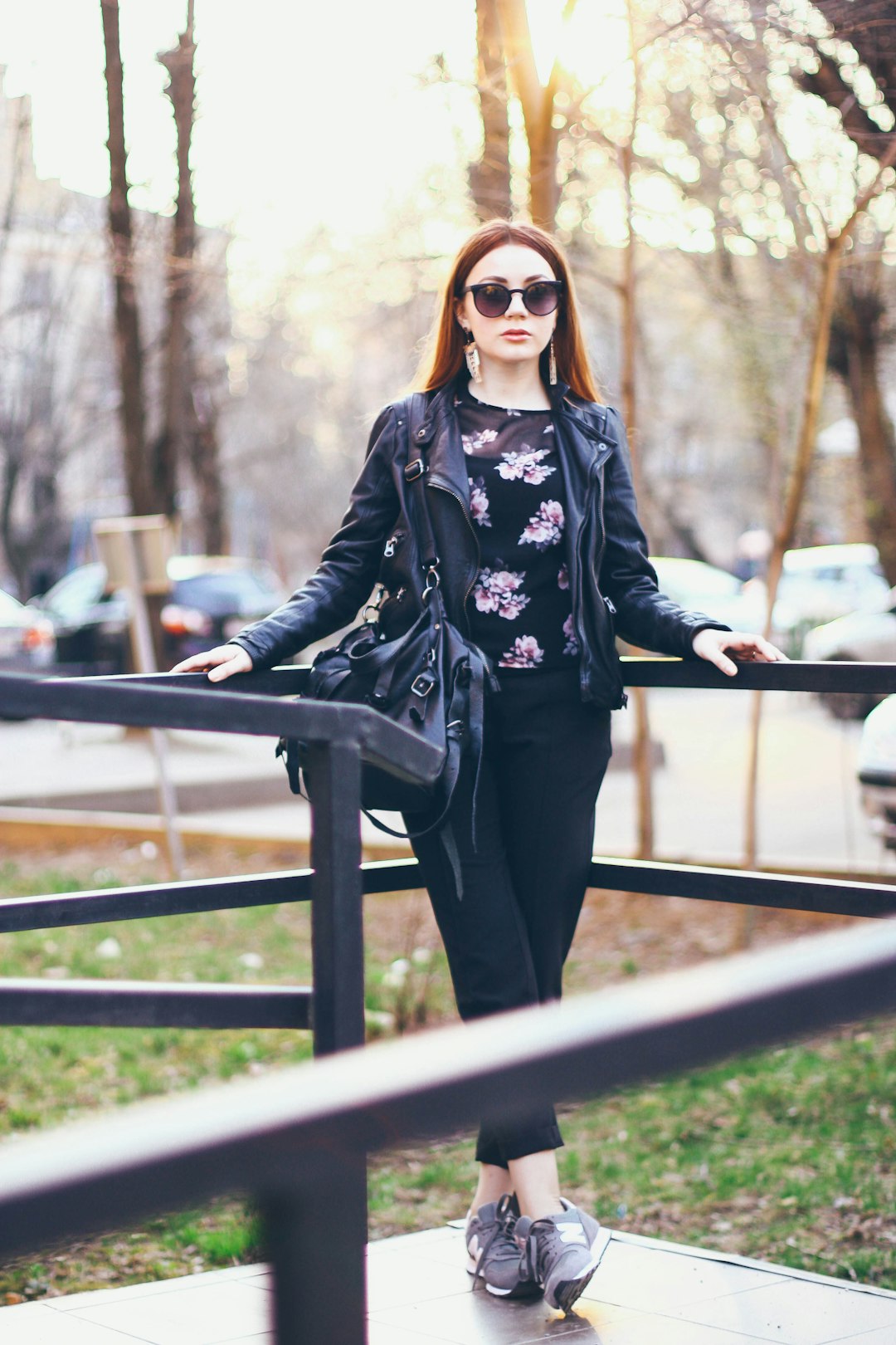 woman in black and white floral long sleeve shirt and black pants wearing sunglasses