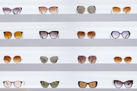 black framed sunglasses on white surface