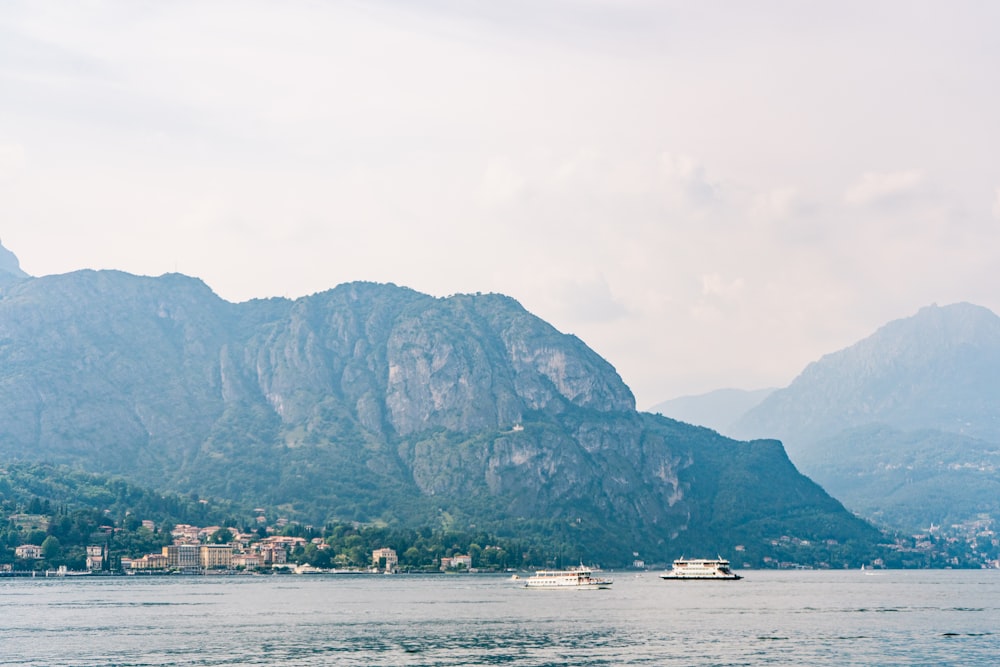 body of water near mountain during daytime