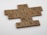 Scrabble tiles arranged on a white surface form the phrase 'In lifting others we rise'. Each tile has a wooden texture and displays both a letter and a corresponding point value.
