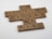 Scrabble tiles arranged on a white surface form the phrase 'In lifting others we rise'. Each tile has a wooden texture and displays both a letter and a corresponding point value.