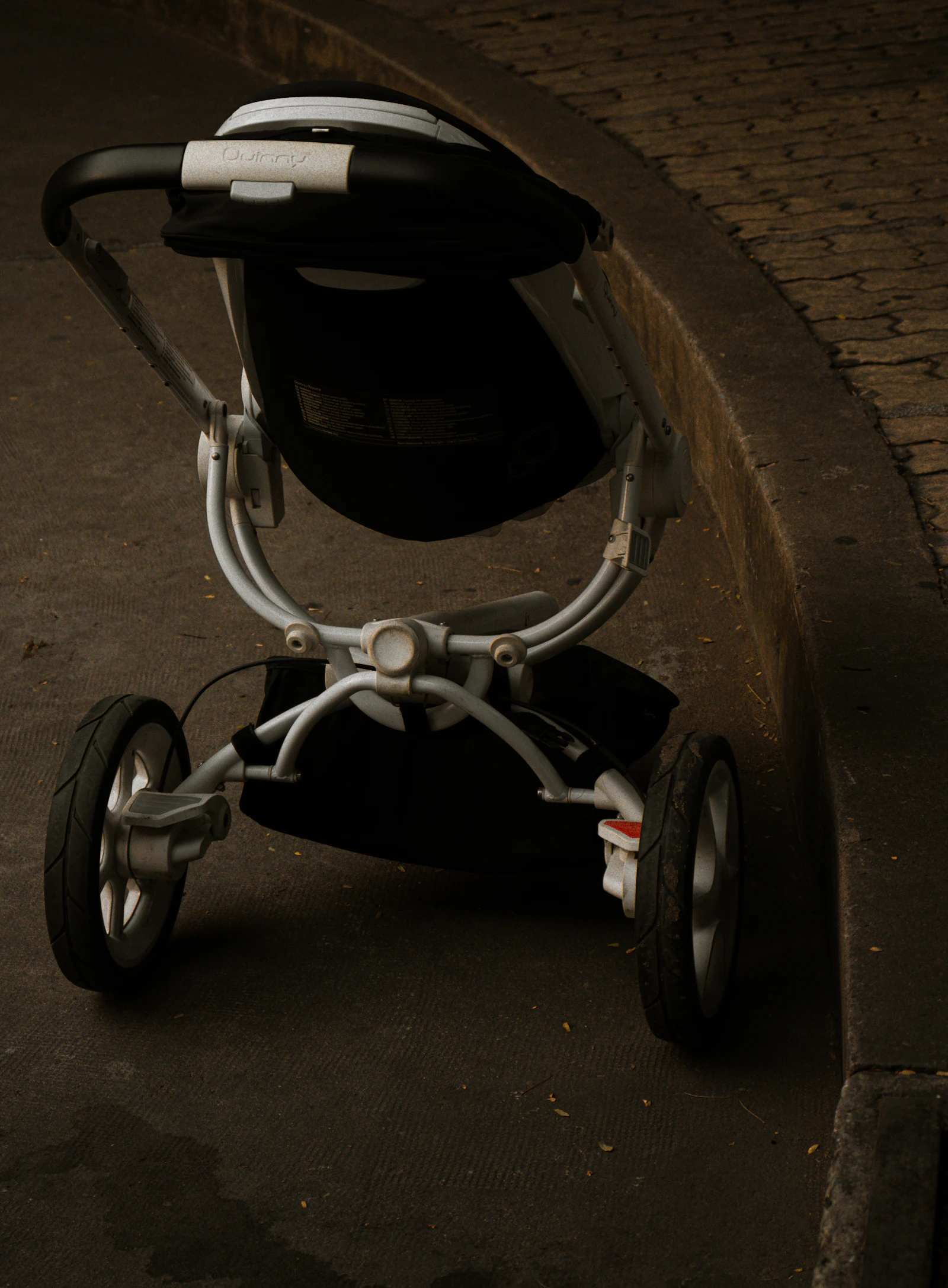 Black and gray baby stroller on pavement