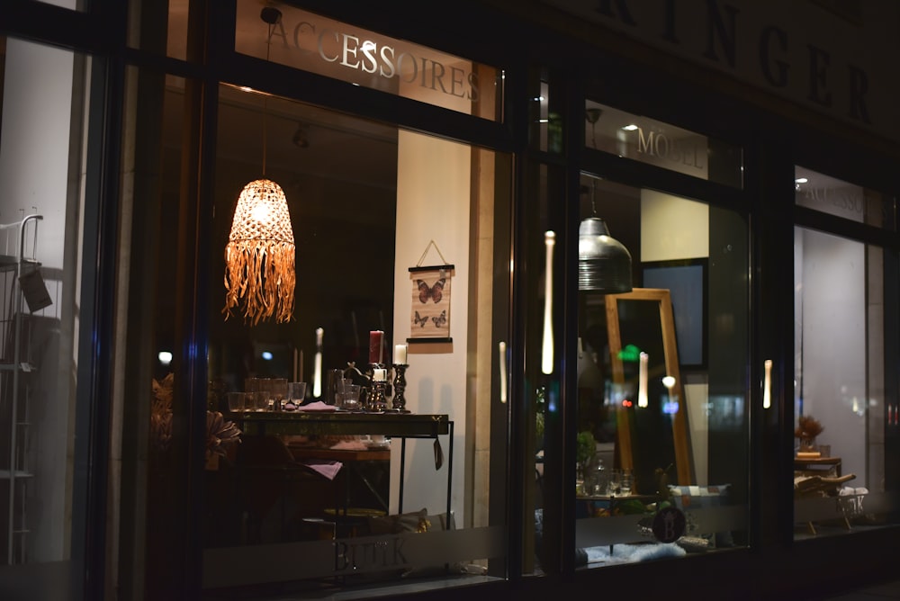 brown pendant lamp turned on near brown wooden table