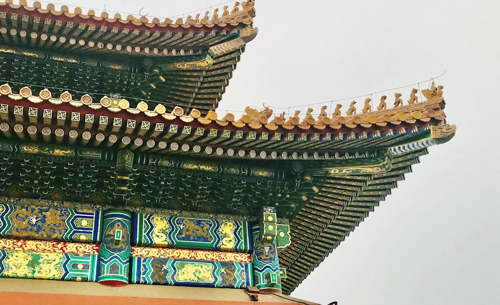 brown and green temple under white sky during daytime