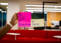 person holding pink sticky notes
