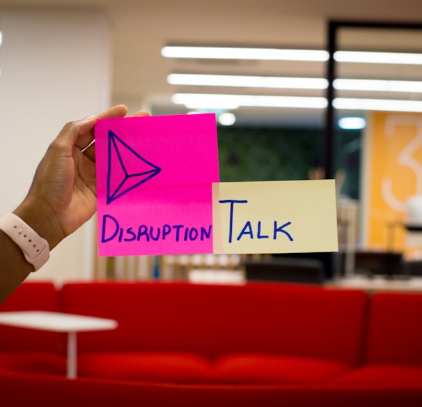 person holding pink sticky notes