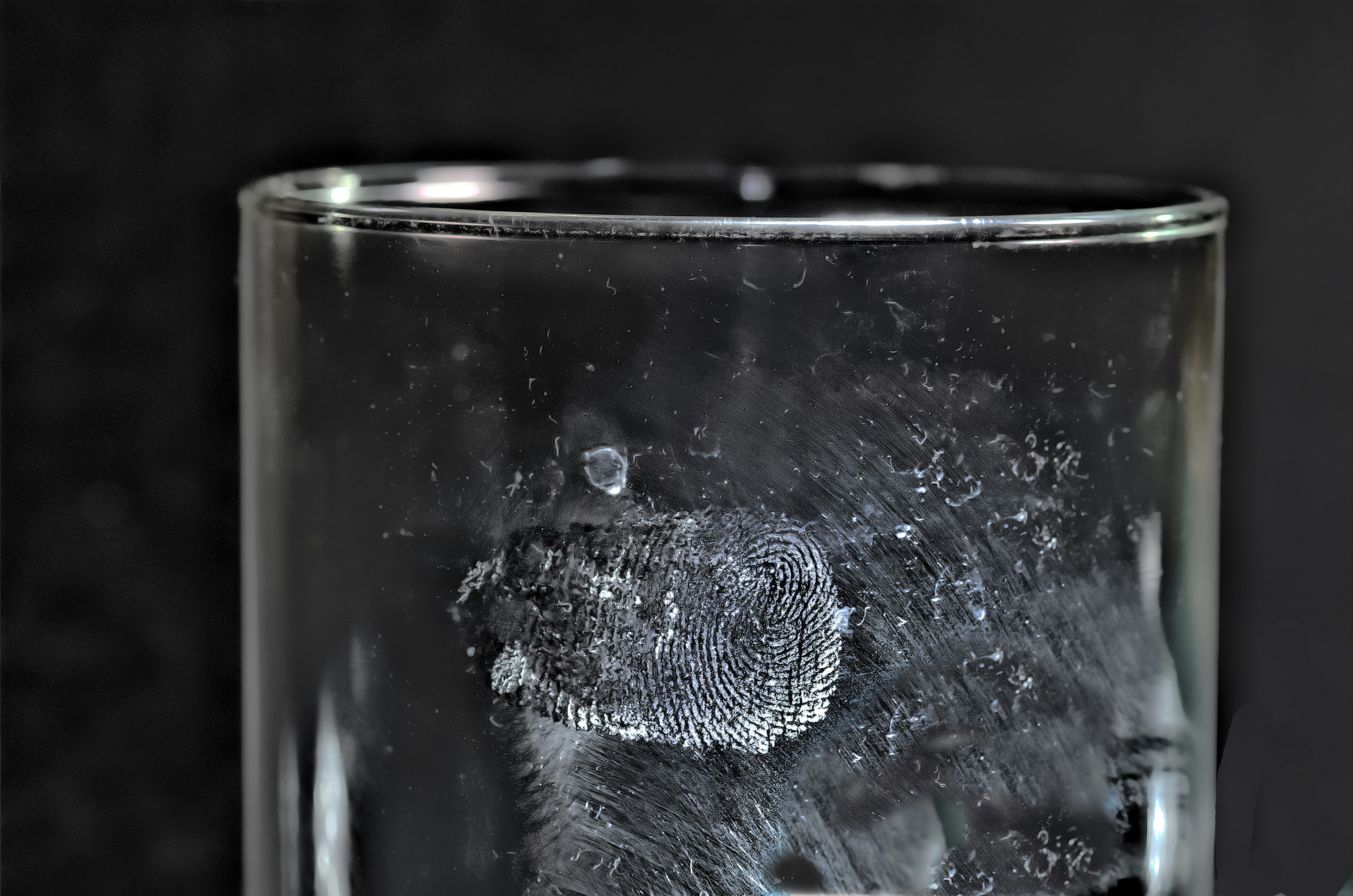 sweat-fingerprint on a glas, photographed with a back-lighting spot