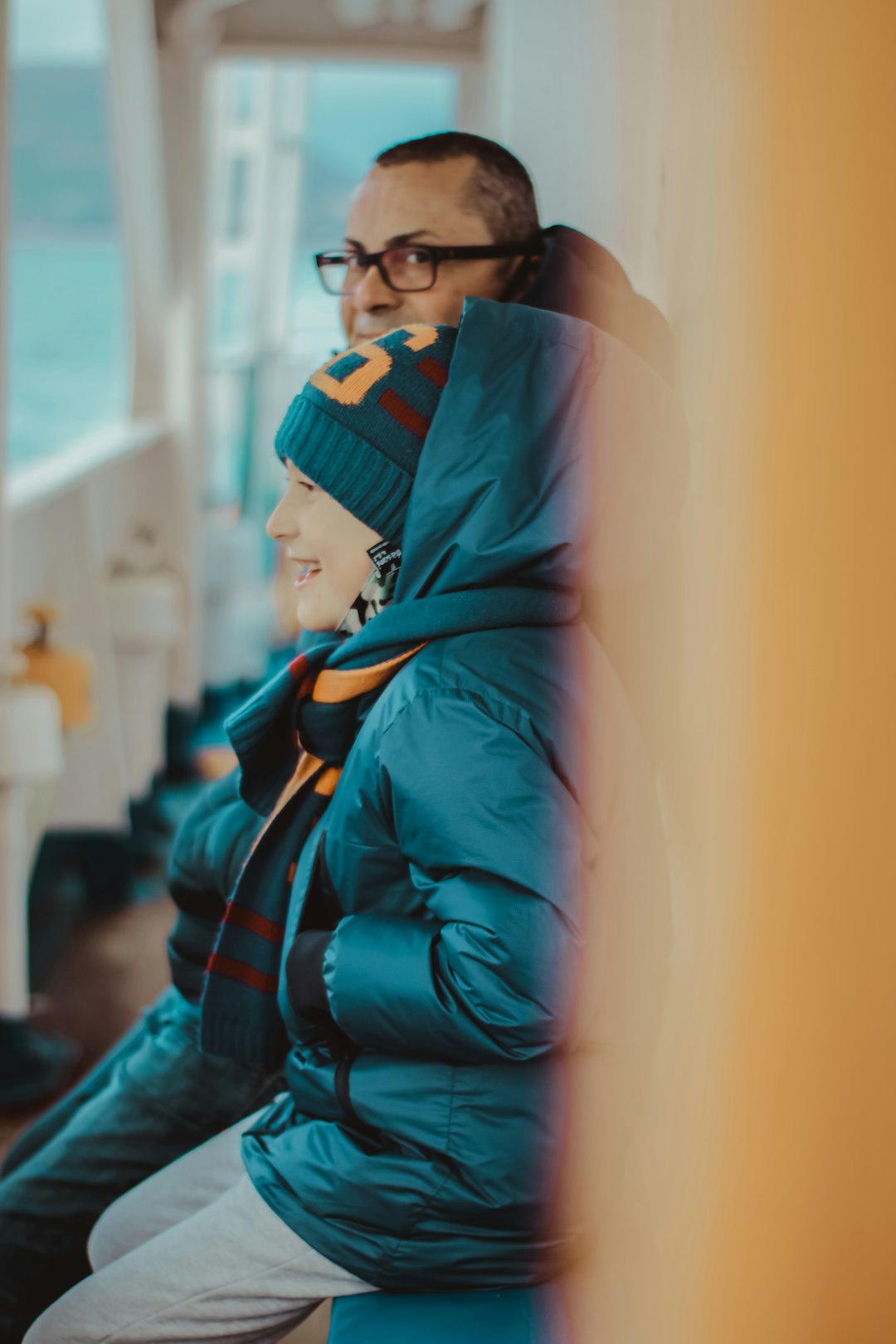 woman in blue and black jacket wearing black framed eyeglasses