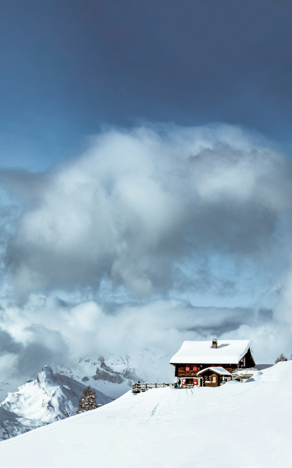 white and brown house under white clouds