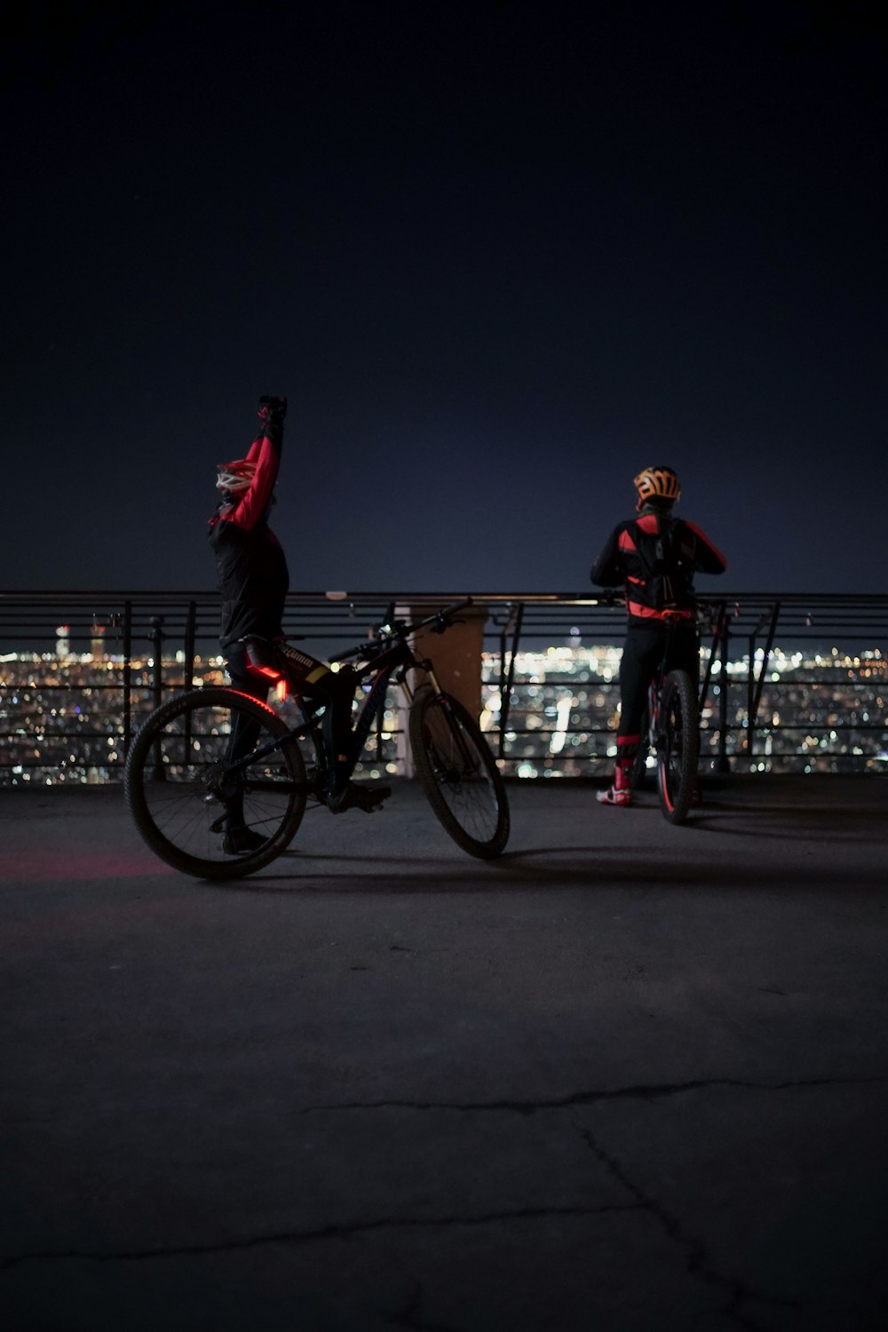 man in red hoodie and red pants riding on bicycle during night time