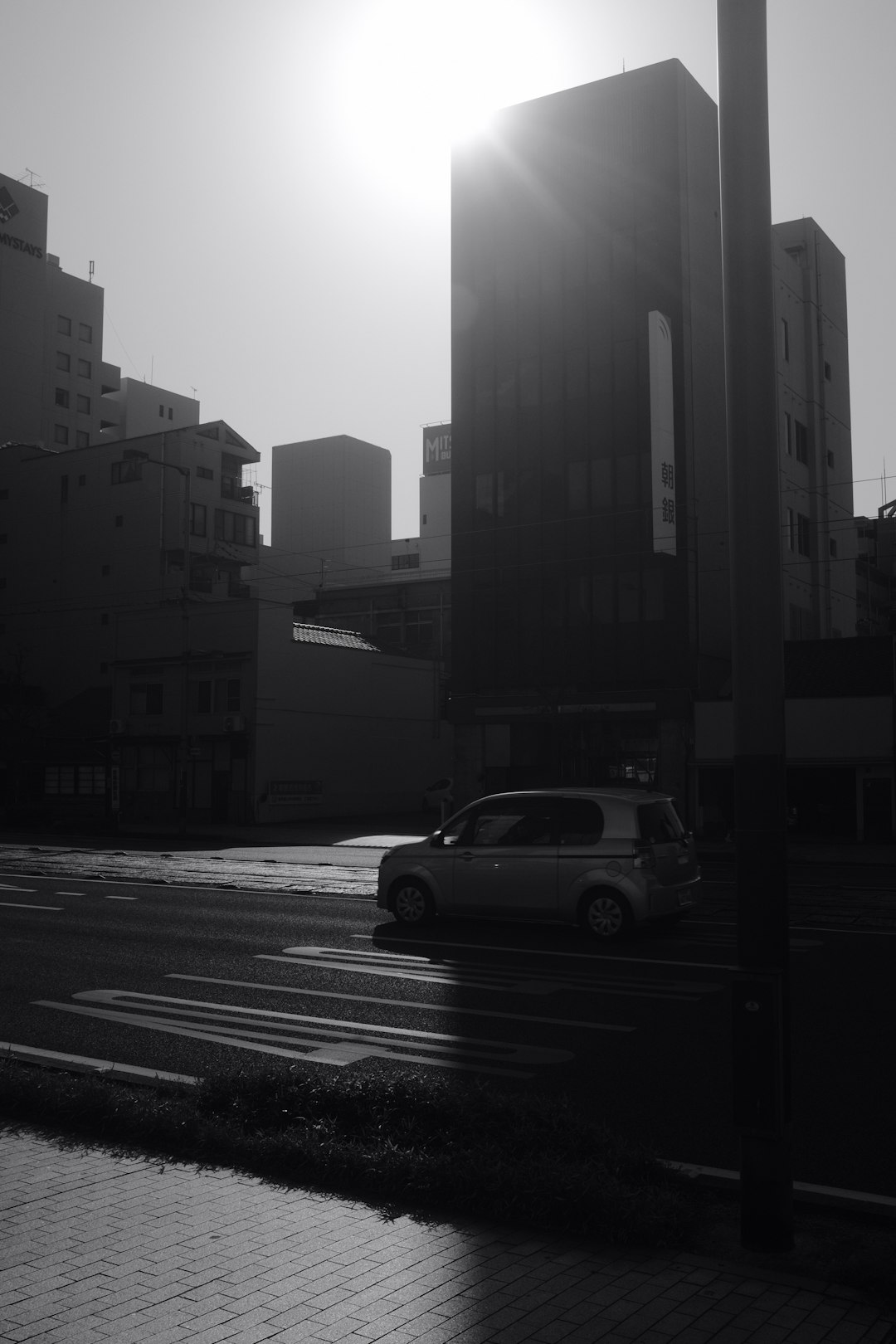 grayscale photo of car on road