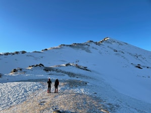 people walking on snow covered ground during daytime