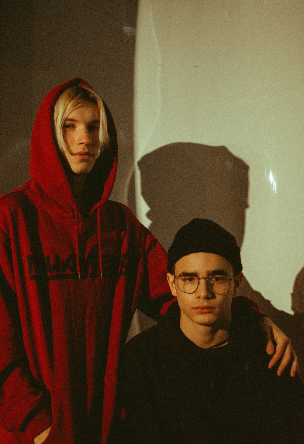 man in black and red hoodie beside woman in black hijab