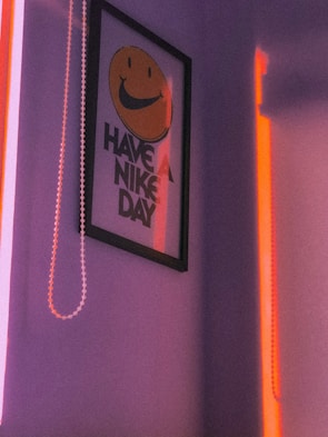 Smiling client holding a vibrant poster designed by Vibhu in a bright studio.