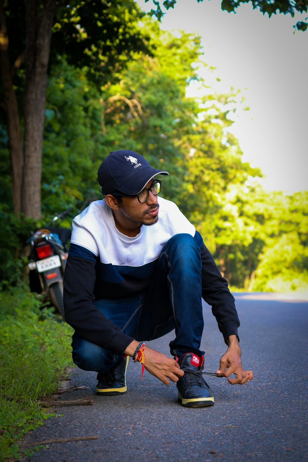 man in blue jacket and blue denim jeans holding red and black camera