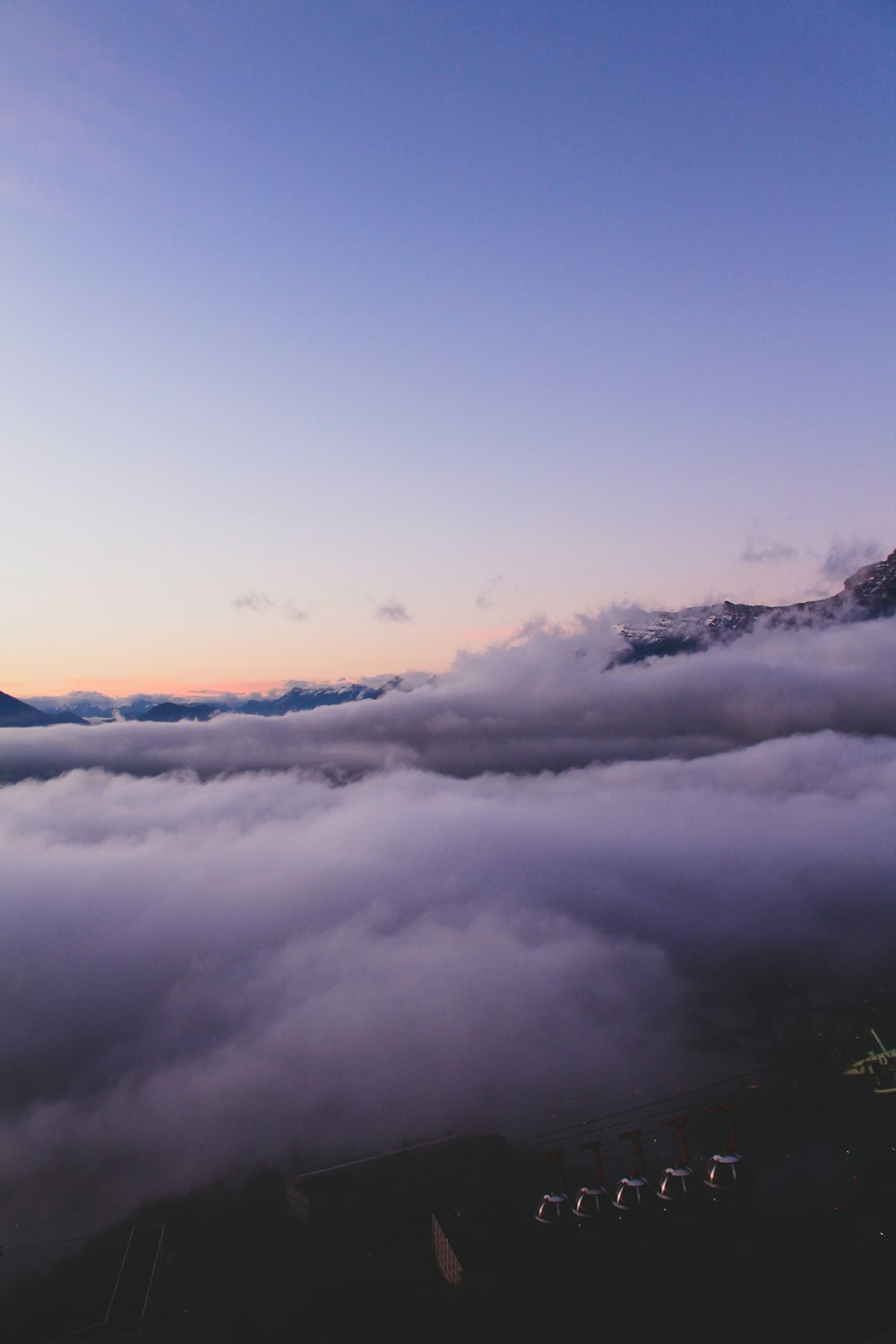 white clouds over mountains during daytime