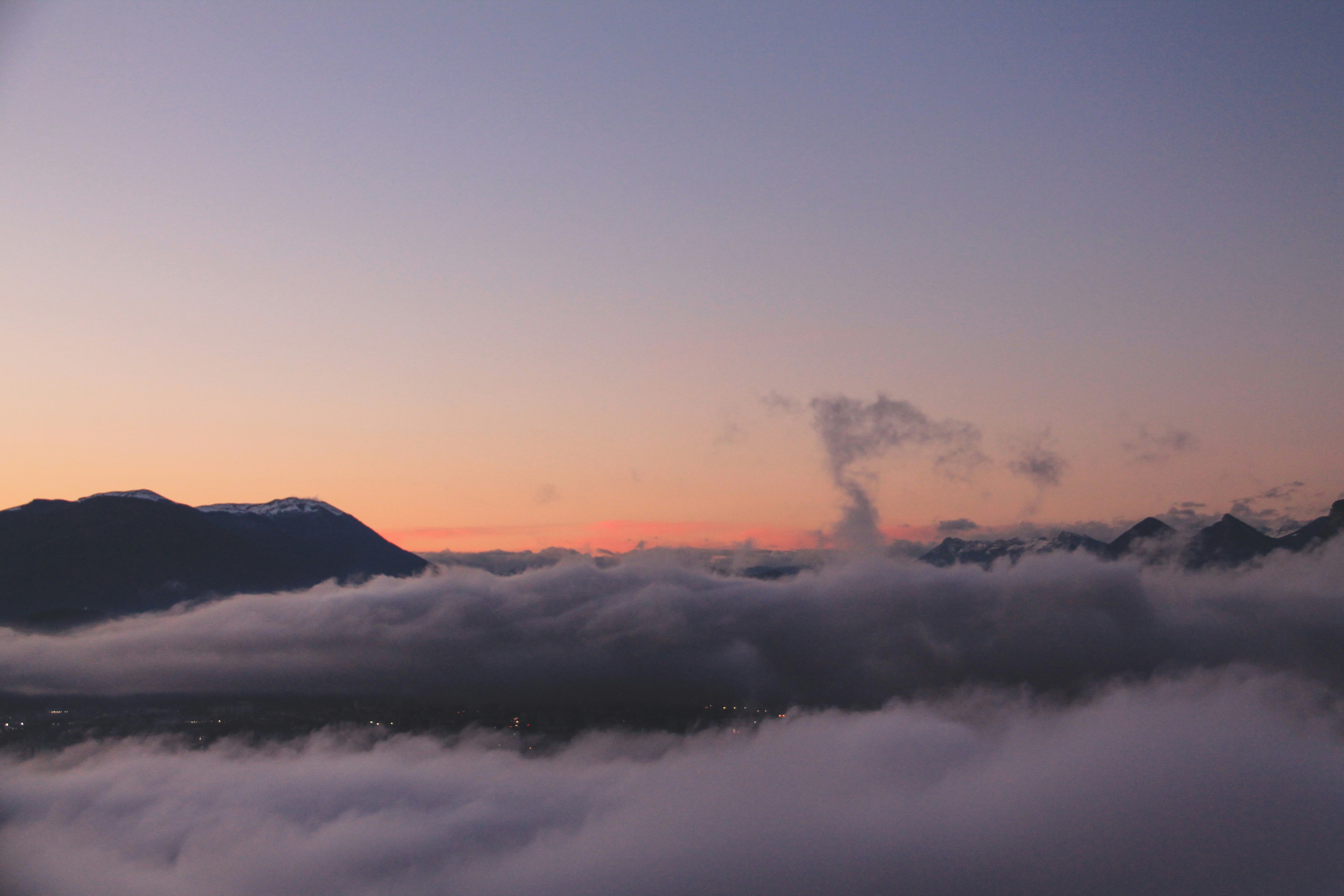 white clouds over mountains during daytime