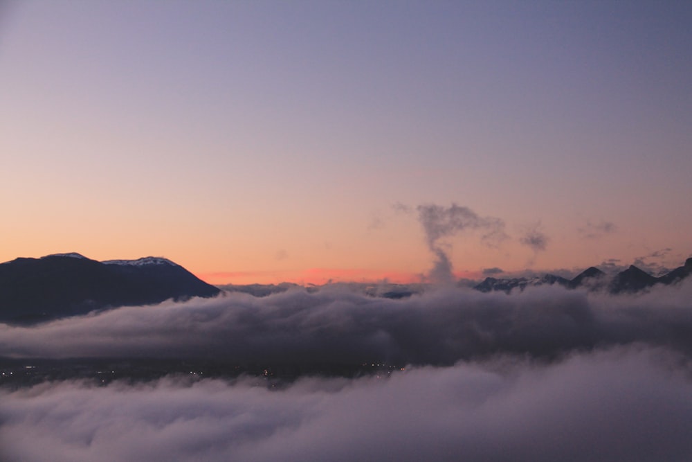 white clouds over mountains during daytime