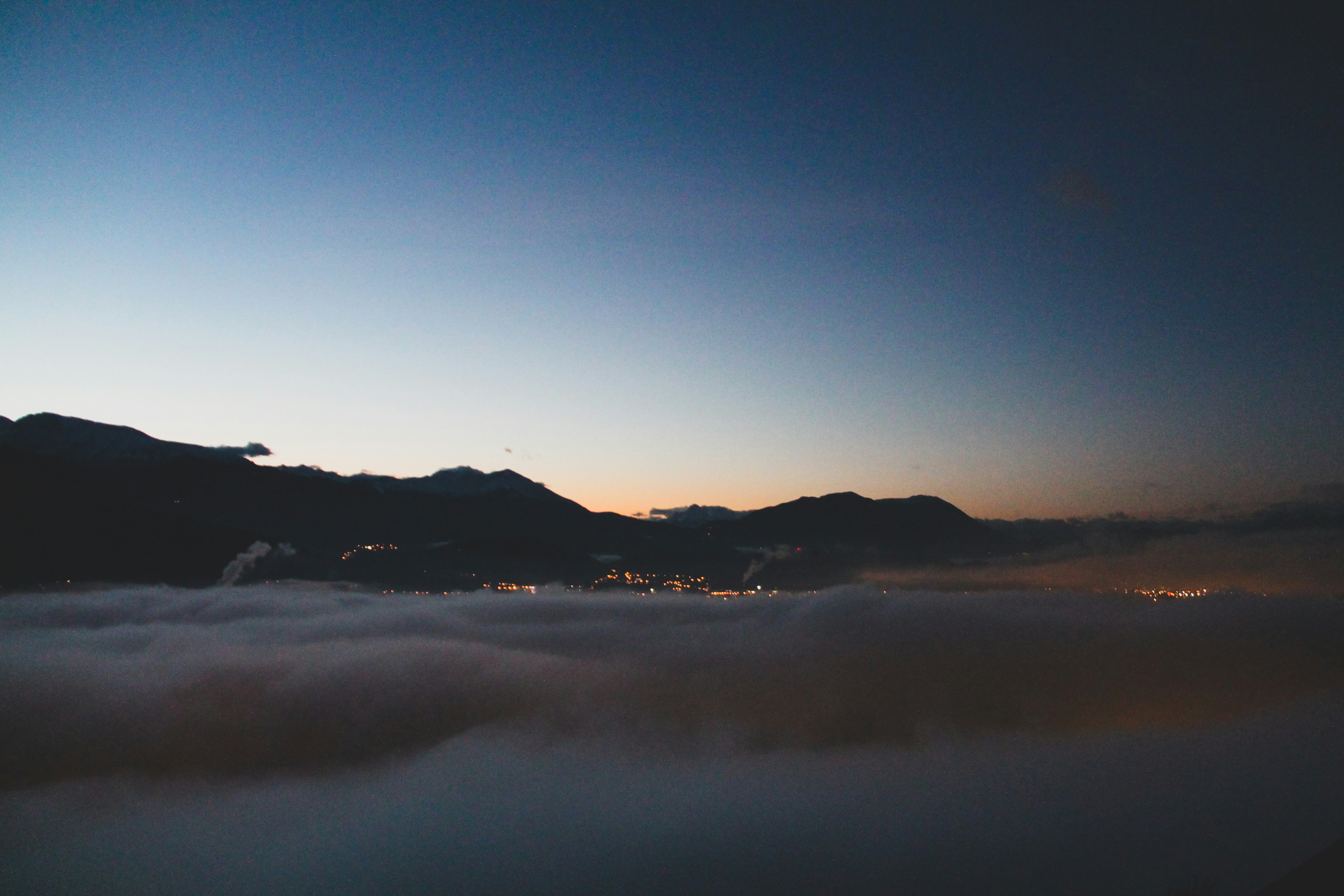 silhouette of mountain during night time