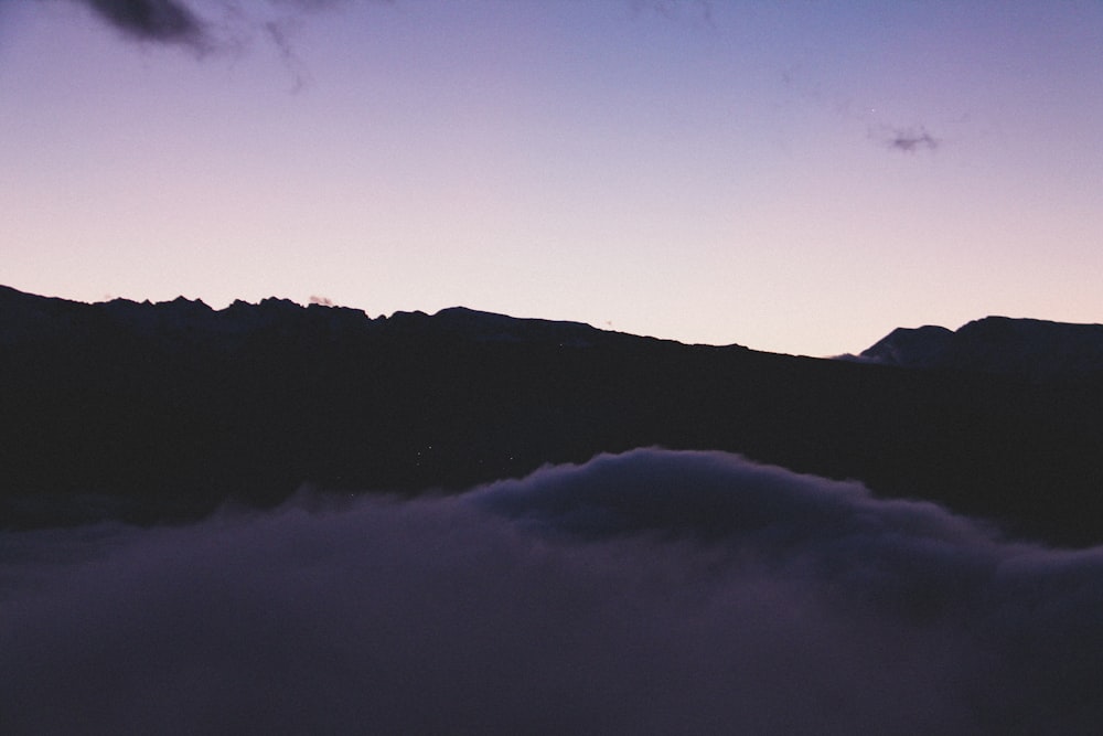 silhouette of mountain under blue sky during daytime