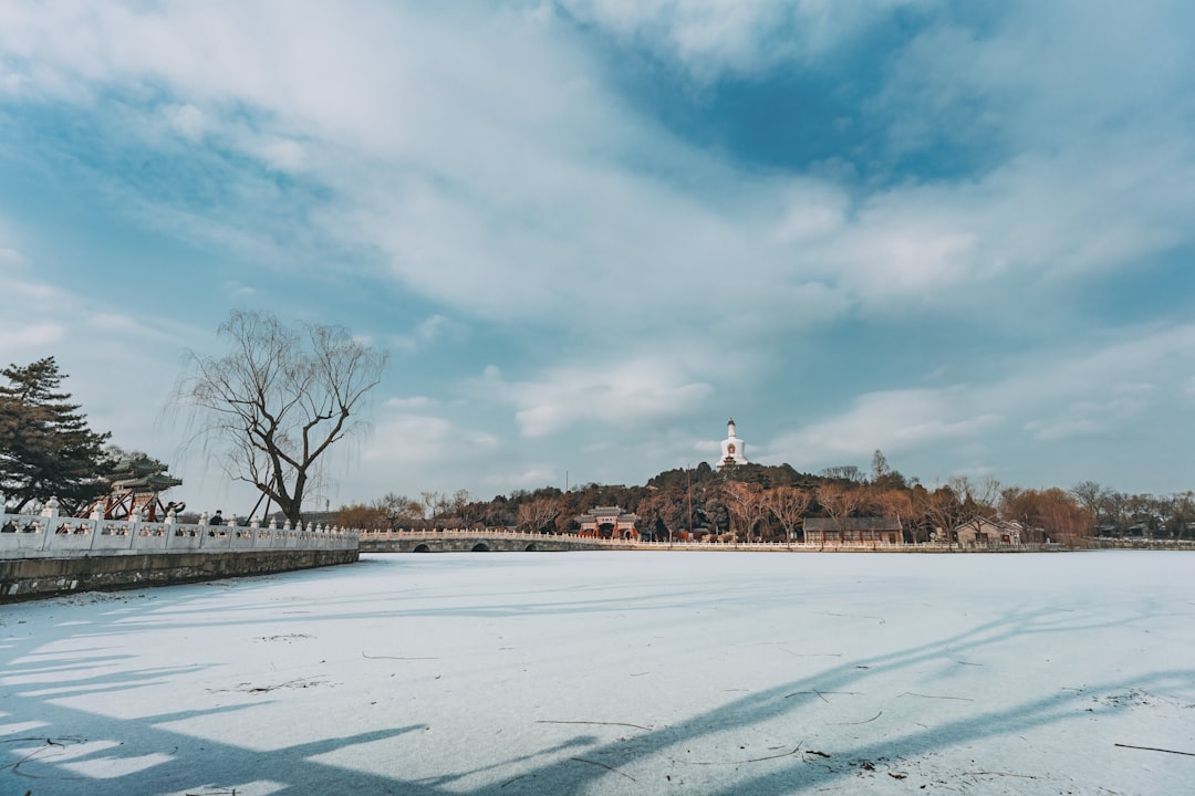 snow covered field under cloudy sky during daytime